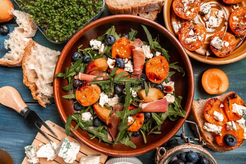 Close-up of Salad with Fresh Arugula Leaves, Peach, Blueberries, Pieces ...