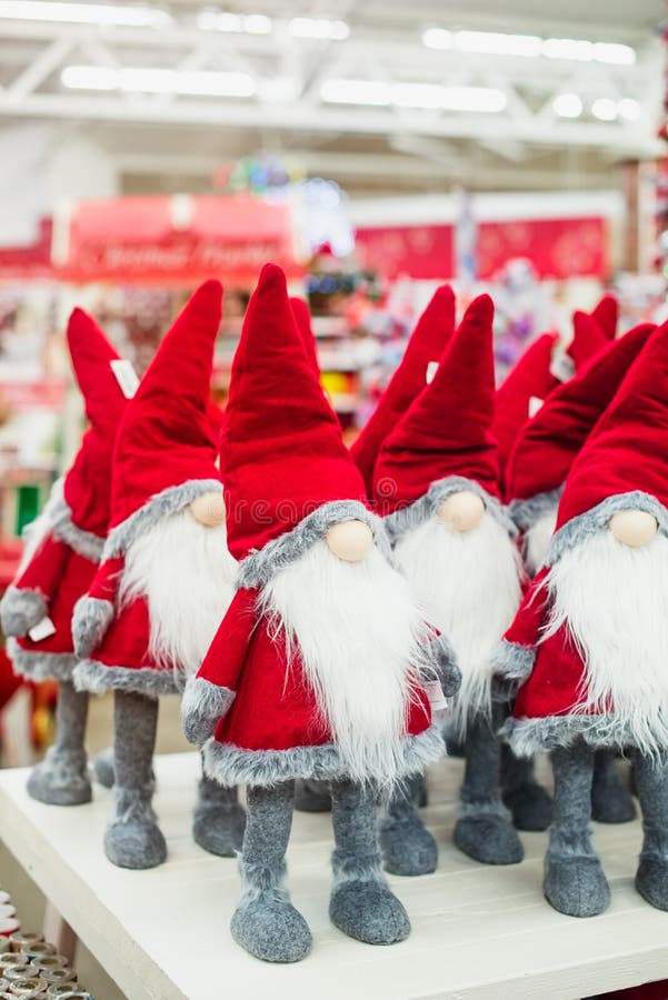 Close up Santa Claus gnome dolls and christmas stuff in the shop christmas market. Vertical crop. Soft selective focus, copy space