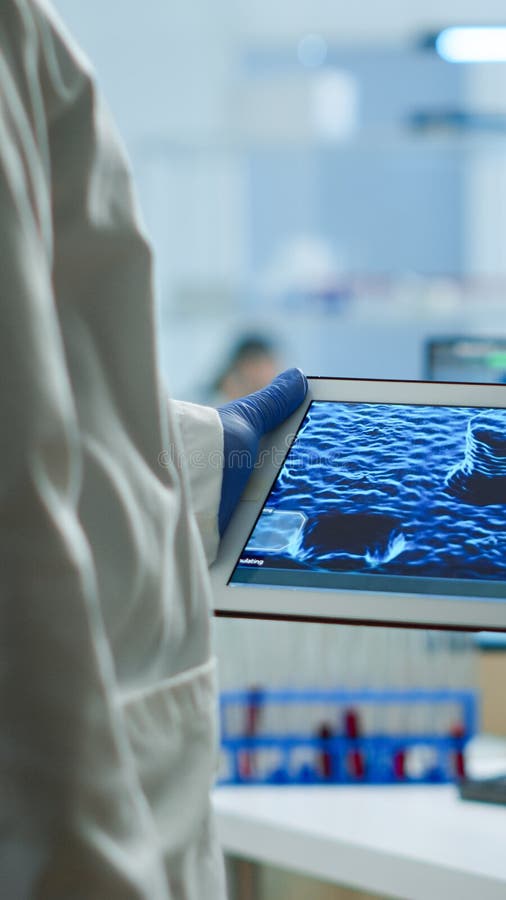 Close up of scientist in lab coat working holding tablet royalty free stock photo