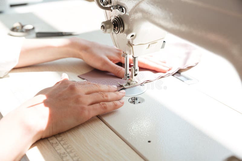 Closeup Seamstress Hands Working on Sewing Machine at Home Stock Photo