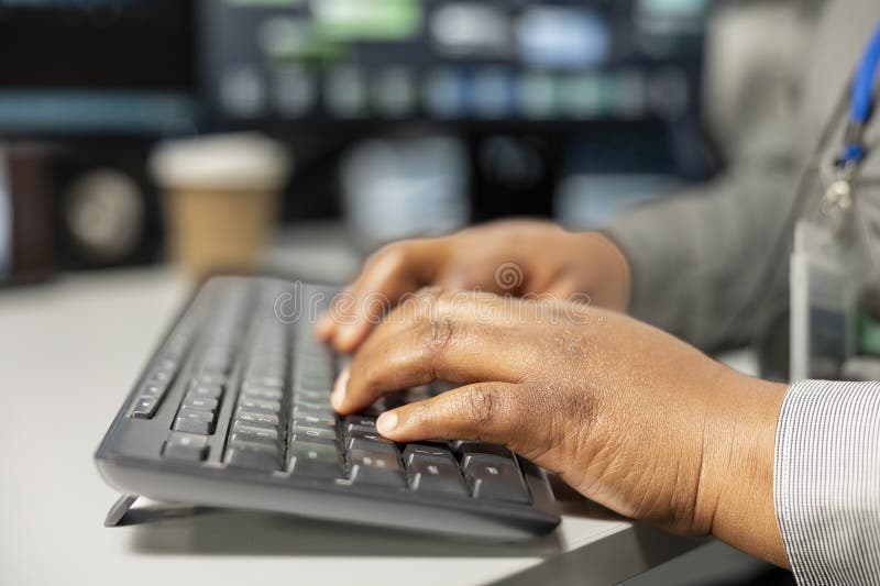 Close up of server room software developer doing data backup, typing on PC royalty free stock photo