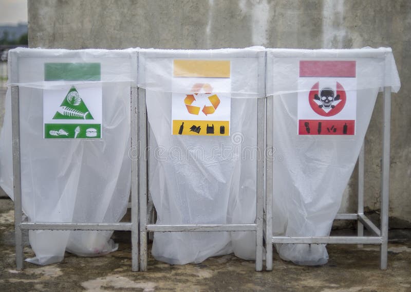 Close Up of a Set of Recycling Bins with Colour Coded Sections for