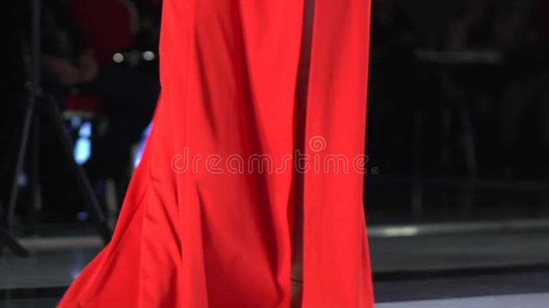 Close up of sexy beautiful female legs in shoes of high heels walking in stage podium, Woman girl in red dress. singer
