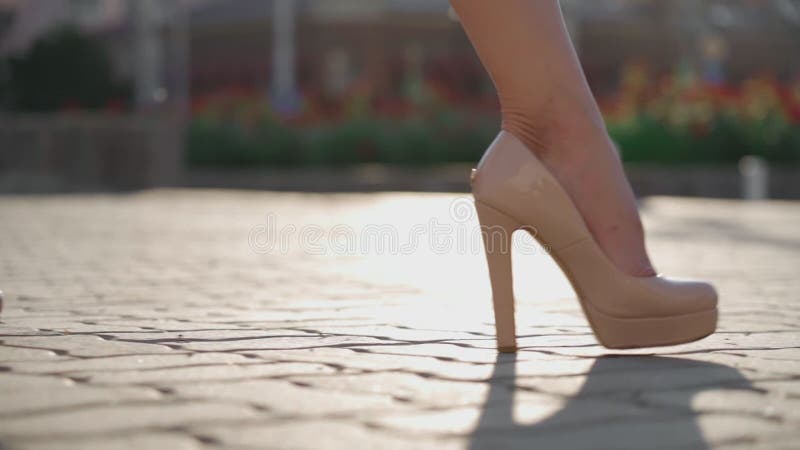 Close-up Unrecognizable Sexy Female Feet in High Heels Walking Along City Street