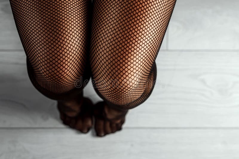 Close-up of Female Legs in Black Stockings photo