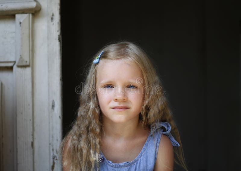 Close up shot of beautiful blonde little girl wearing jeans dress, looking at the camera royalty free stock images Close up shot of beautiful blonde little girl wearing jeans dress, looking at the camera royalty free stock images