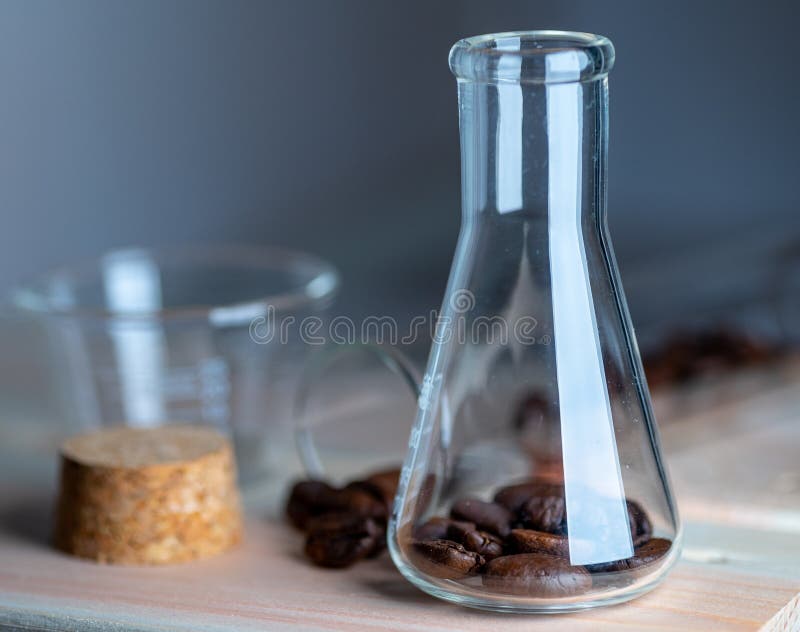 Close Up Shot of Coffee Beans in Laboratory Glassware Stock Image