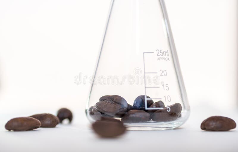 Close up shot of coffee beans in laboratory glassware