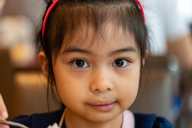 Close Up Shot of a Female Asian Child Serious while Looking at Camera ...