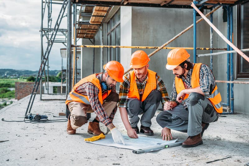 Close-up Shot of Group of Happy Builders Having Conversation about ...