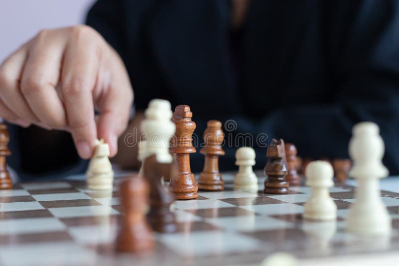 Close up shot hand of business woman playing the chess board to win by killing the king of opponent metaphor business competition winner and loser select focus shallow depth of field, strategy, game, concept, success, leisure, white, piece, intelligence, move, challenge, leadership, black, battle, corporate, victory, fight, sport, player, background, people, thinking, decision, pawn, defeat, power, plan, holding, team, conflict, war, queen, chessboard, risk, knight, young, idea, businessman, strategic, teamwork