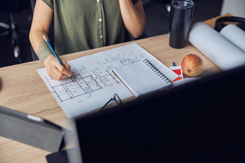 Close Up Shot of Hand of Female Interior Designer Making Notes on a