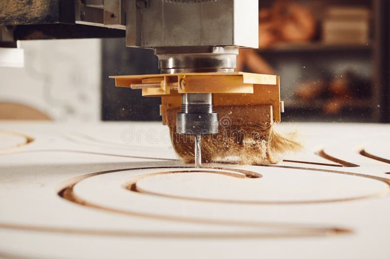 Close-up shot of machine with numerical control cuts wood. Cnc tool. stock images