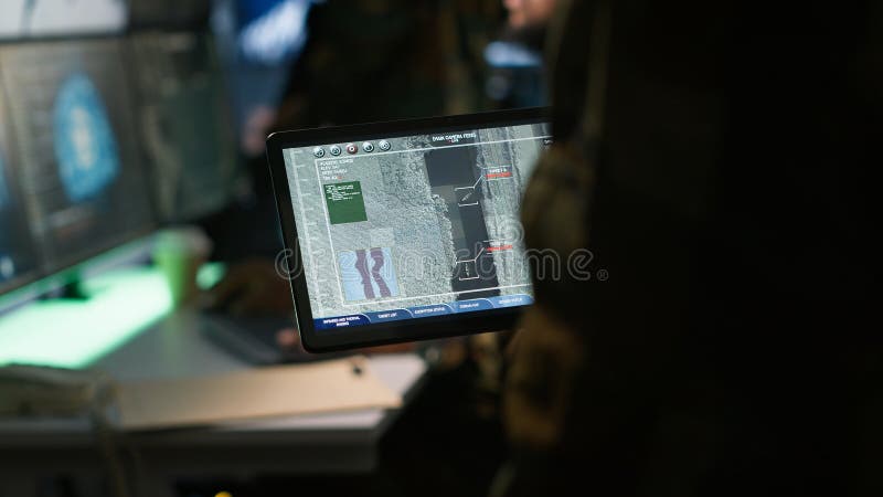 Close up shot of officer using software on device to do assessment of enemy royalty free stock image