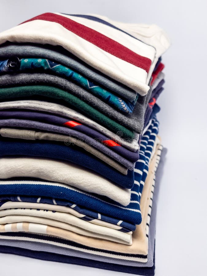 Stack of neatly folded colorful clothes on a plain white background royalty free stock photos