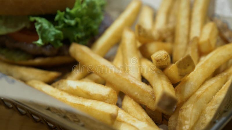 Close up shot of tasty french fries and burger, fast food