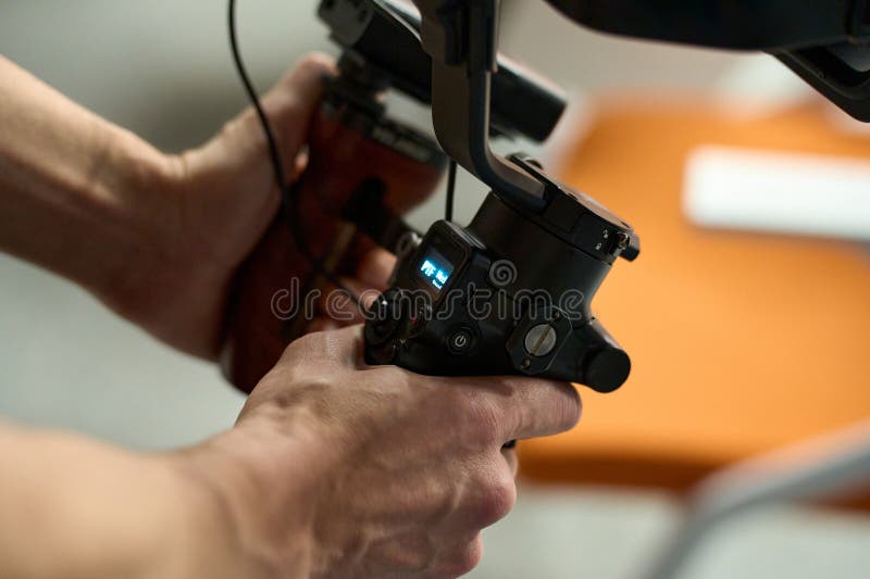 Close-Up of Videographer Operating Gimbal Camera stock photo