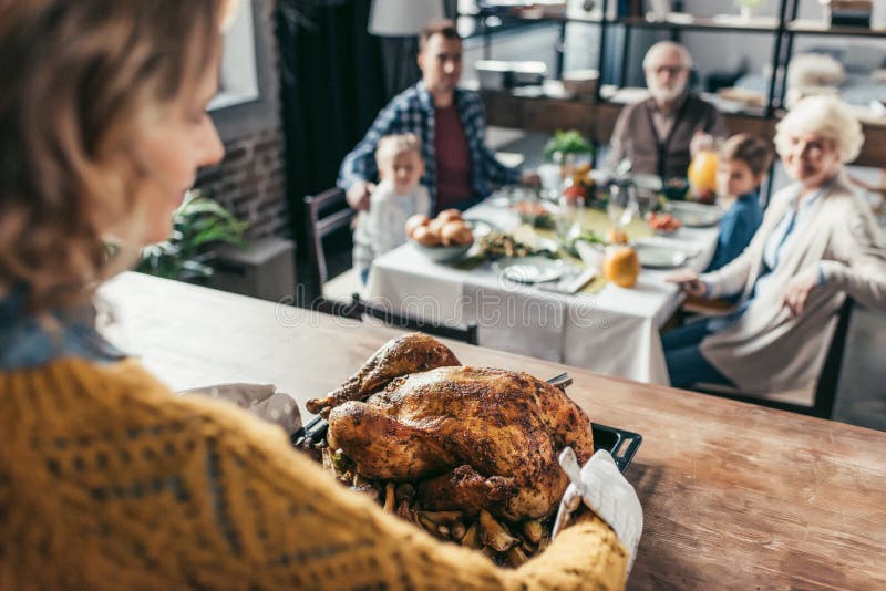 close-up shot of woman with thanksgiving turkey for holiday dinner