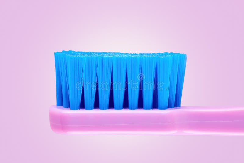 Close up side view of a purple toothbrush on purple background royalty free stock photography