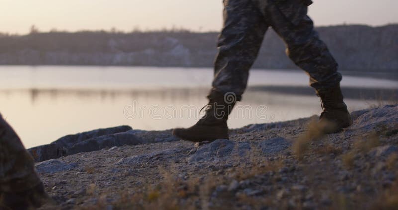 Soldiers walking by the lake