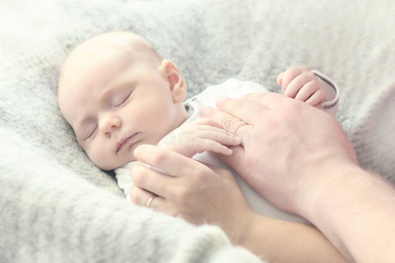 Close-up of small boy with mother and father hands stock image Close-up of small boy with mother and father hands stock image