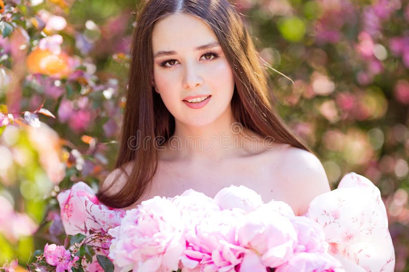Close Up Of Smiling Beautiful Girl Holding A Large Bouquet Of Pink