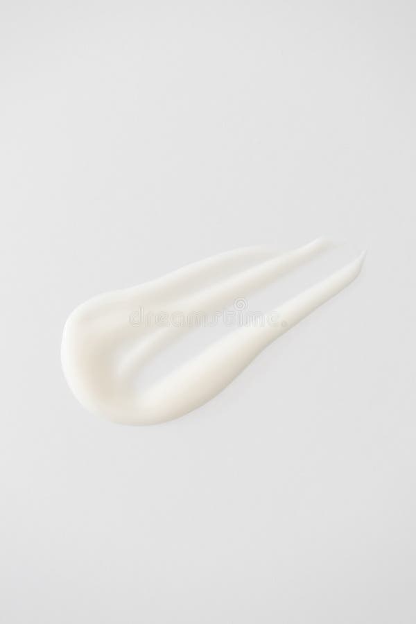 Close-up smooth white cream or lotion swatch on a minimal white background. Creamy texture skincare beauty product royalty free stock photography