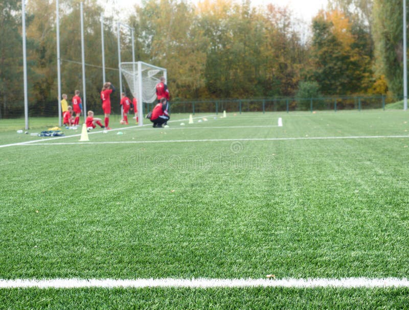 Close-up of soccer turf within kids training.  Green grass