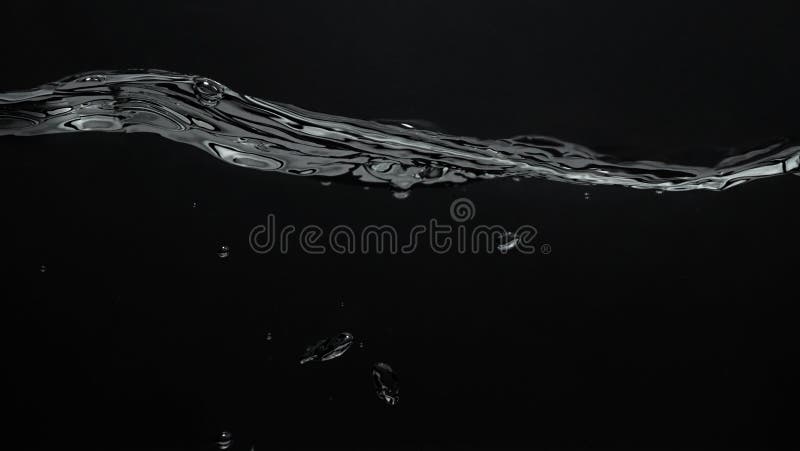 Close up soda water bubbles floating up to top of water surface royalty free stock image