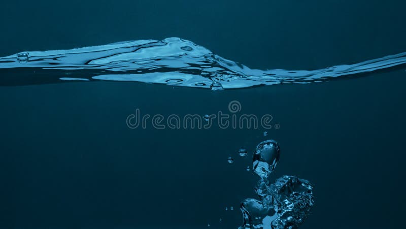Close up soda water bubbles floating up to top of water surface royalty free stock images