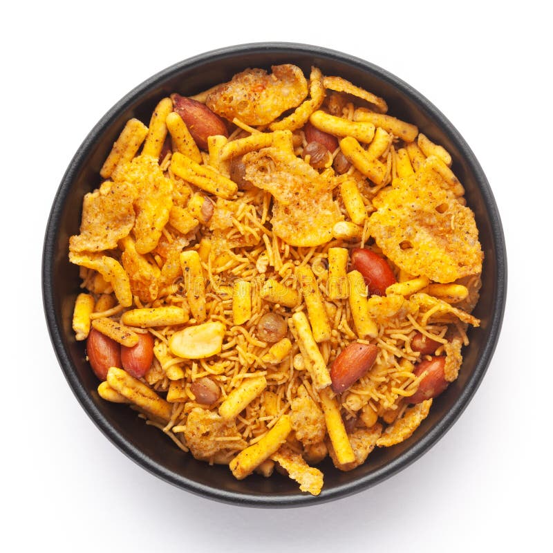 Close-Up of Spicy Chatpata Mixture in a black Ceramic bowl made with peanuts, corn flakes. Indian spicy snacks Namkeen