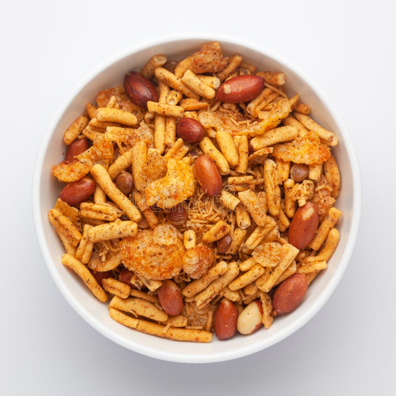 Close-Up of Spicy Chatpata Mixture in a white Ceramic bowl made with peanuts, corn flakes. Indian spicy snacks Namkeen