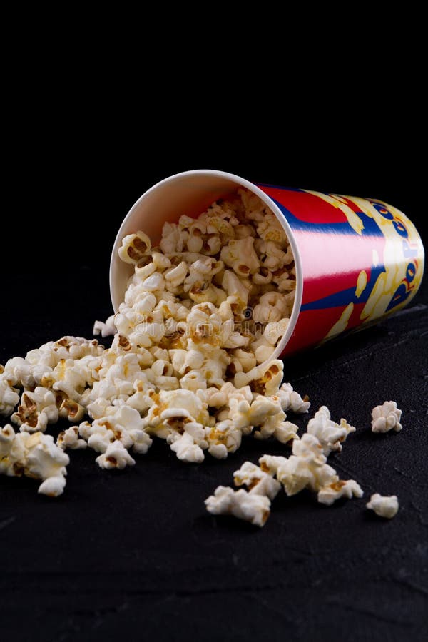 Spilled Popcorn And Paper Bucket In Red Strip On Blue. Copy Space For