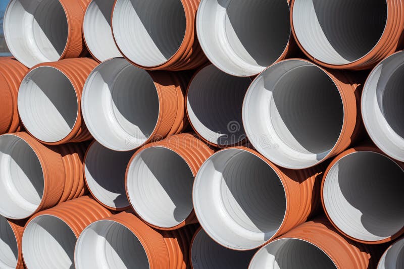 Closeup Stack of New Orange Polypropylene Pipes. Plastic Pipes for