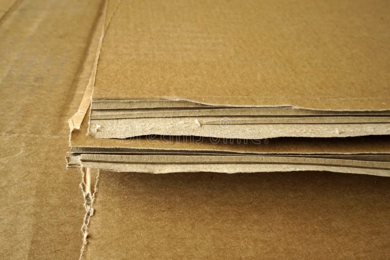 Closeup of Stacked Corrugated Cardboard. Sheets of Brown Corrugated
