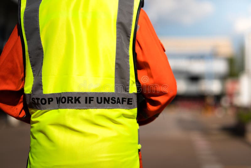 `Stop work if unsafe` on reflective vest for worker.