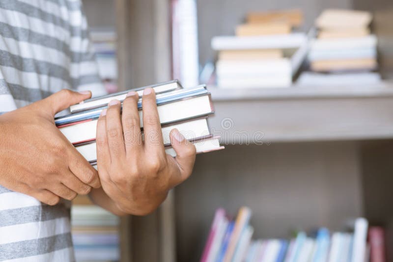 Close up student young man hand holding books are placed front royalty free stock image Close up student young man hand holding books are placed front royalty free stock image