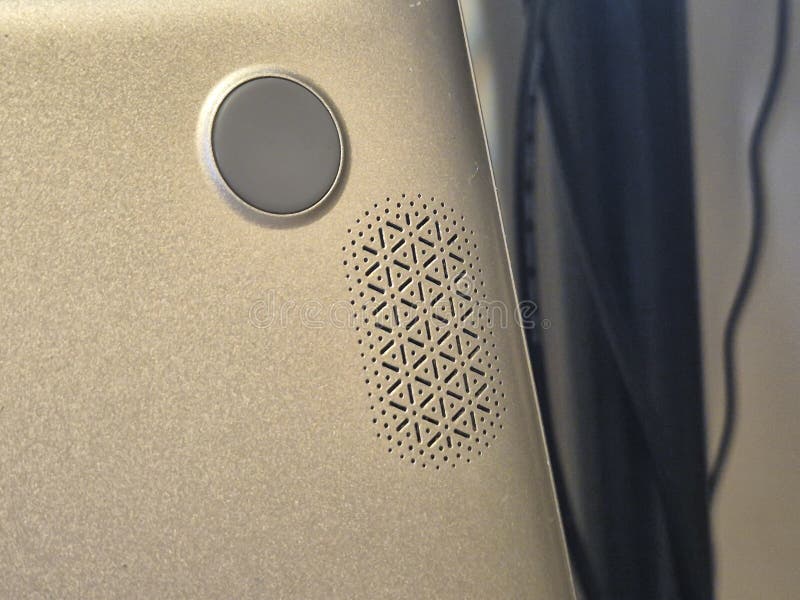 Close-up of a stylish electronic device showcasing its unique speaker design and button. Perfect for tech enthusiasts an stock photography