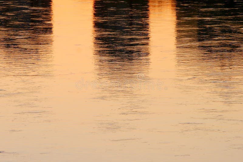 Close up of sunset water reflection. Sunlight and skyscraper reflection on the water surface of river stock photography Close up of sunset water reflection. Sunlight and skyscraper reflection on the water surface of river stock photography