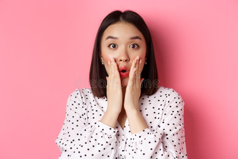 Close Up Of Surprised And Amazed Asian Woman Staring At Camera Gasping