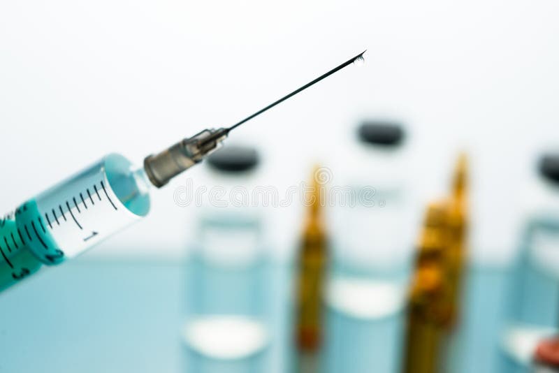 Close up Syringe needle medicine with liquid medicine drop