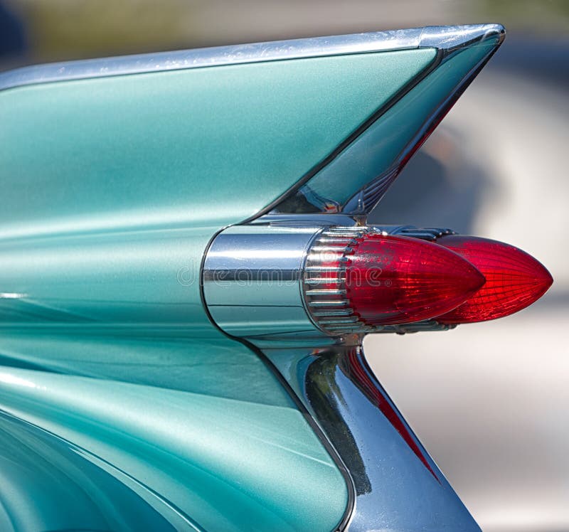 Straight lines, curves, chrome and red tail lights of an American classic car. Straight lines, curves, chrome and red tail lights of an American classic car.