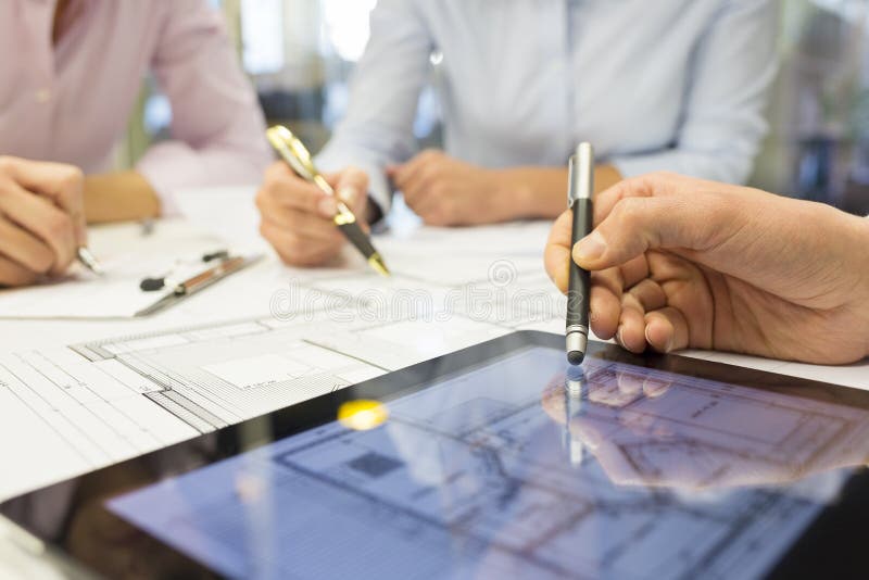 Close-up of Team architects working on construction project in o royalty free stock image