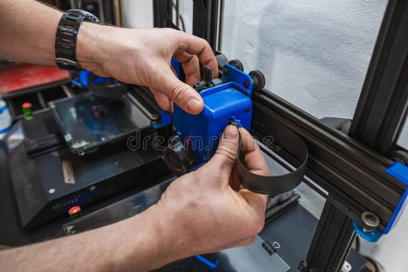 Close-up of technician doing 3D printer repair royalty free stock image