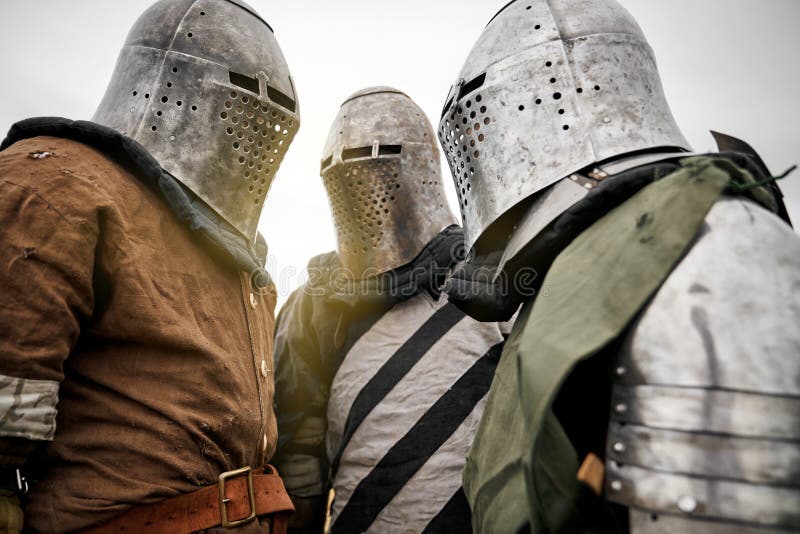 Three medieval knights in armor. stock photos Three medieval knights in armor. stock photos