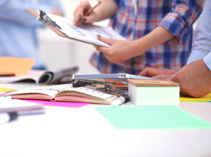 Close-up of three young creative designers working stock images Close-up of three young creative designers working stock images