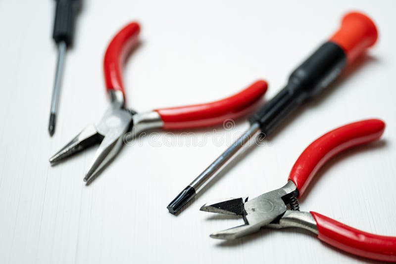 Electronics Repair Tools are Lined in a Row at the Bottom of the White