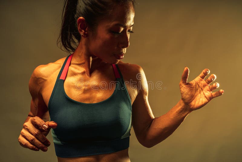 Close up of the top part of muscle lean healthy body of 40 year old asian woman in fitness training tops show the muscle and sweat royalty free stock photo Close up of the top part of muscle lean healthy body of 40 year old asian woman in fitness training tops show the muscle and sweat royalty free stock photo