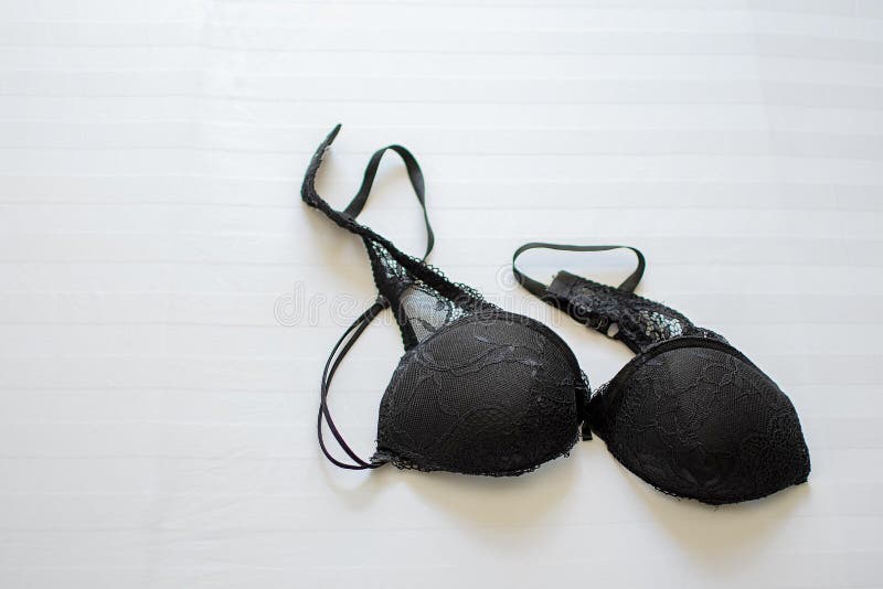 Black bra on bed sheet Stock Photo - Alamy