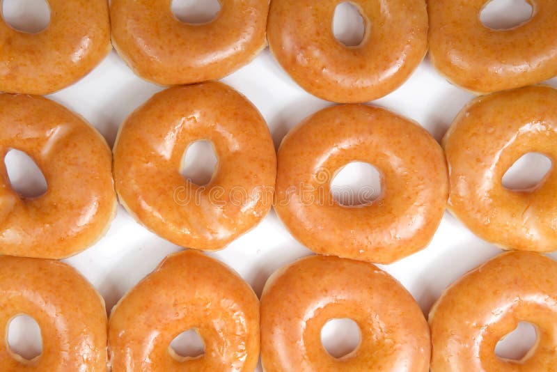 A pile of glazed donuts sitting on top of a table photo – Donut Image on  Unsplash